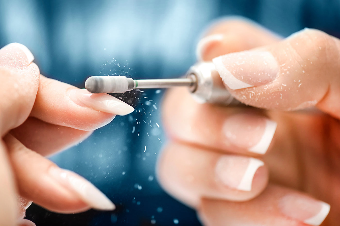 nail professional filing a nail 