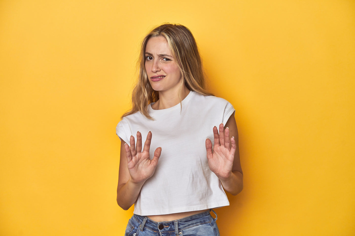 Woman looking disgusted and gesturing it with her hands